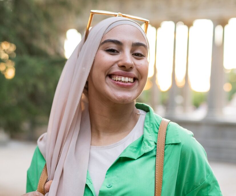arabic muslim woman traveler backpacker, europe, visiting city, selfie.